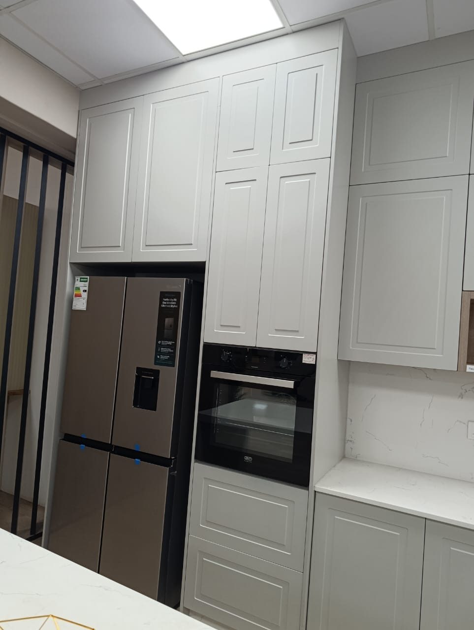 Fitted kitchen units with built-in oven and fridge housing