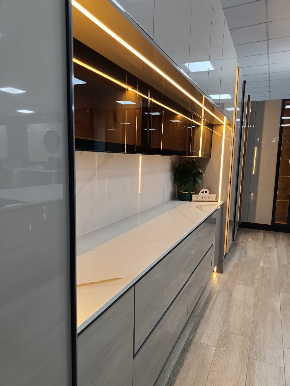 Modern fitted kitchen with stone countertops and LED lighting