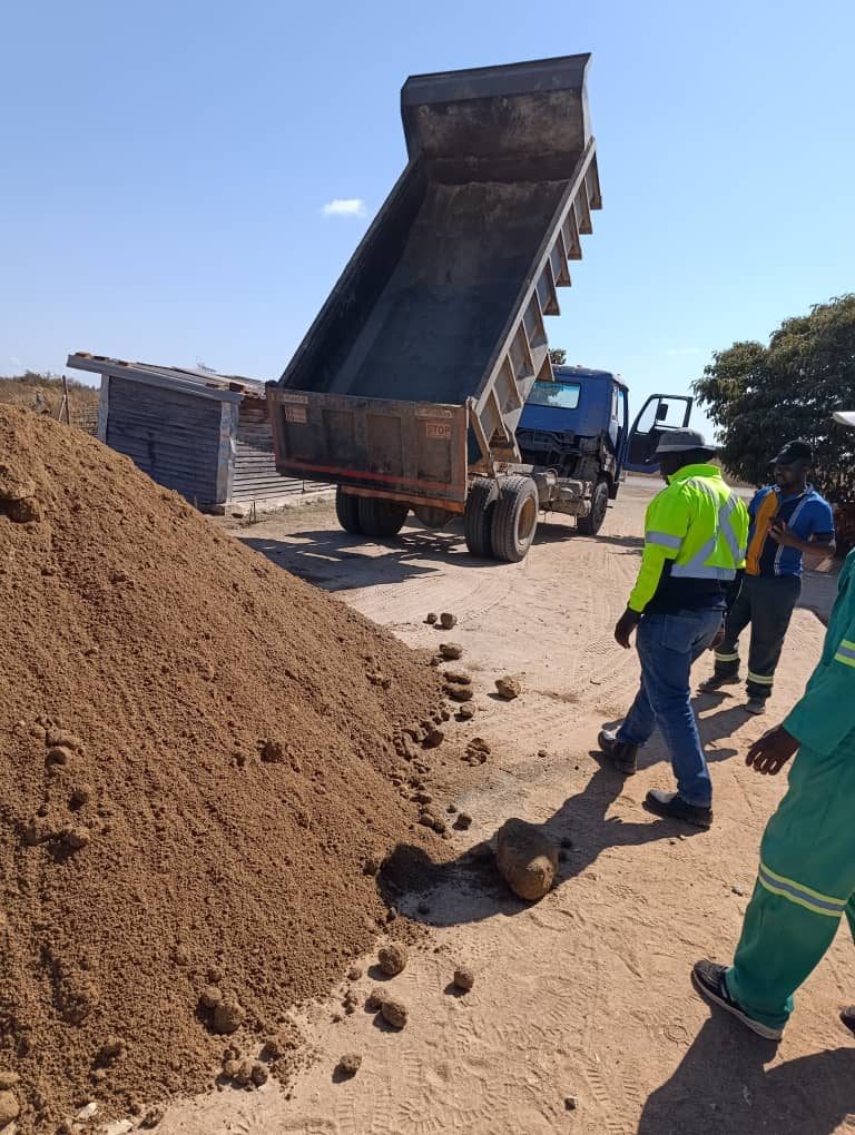 Tipper truck offloading river sand